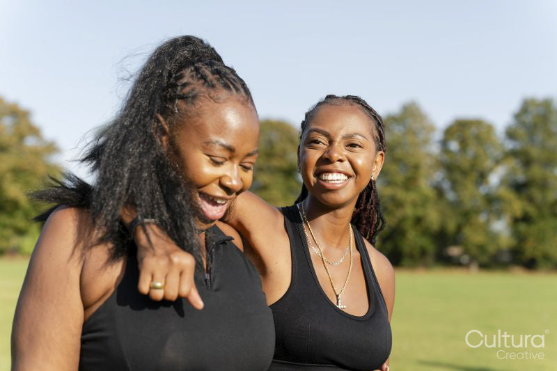 Young female friends walking in park after exercising
