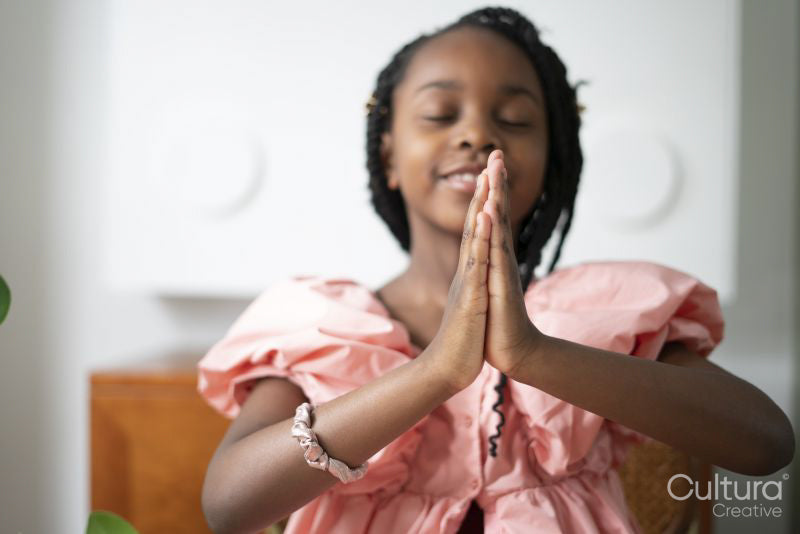 Smiling girl praying