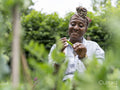 Woman holding green beans collected from garden