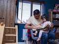 Father reading book to daughter