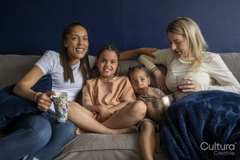 Mothers and sons watching TV