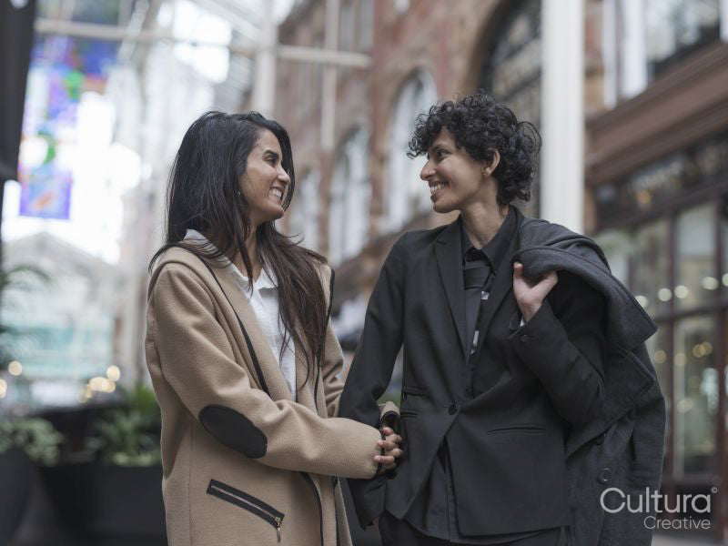 Female couple walking in street