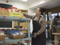 Female volunteer working in community food center