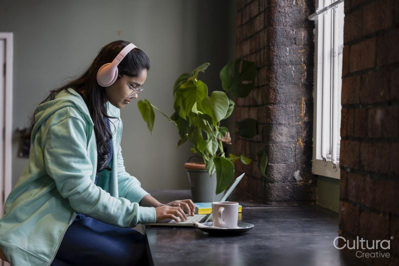 Female student using laptop while studying