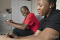 Teenage friends playing video game at home