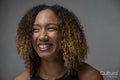 Portrait of smiling woman with curly hair