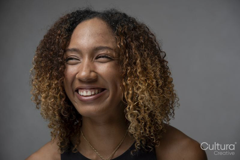 Portrait of smiling woman with curly hair