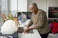 Woman washing dishes in kitchen