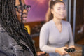 Female friends playing in video games at pub