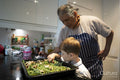 Senior man with grandson cooking together