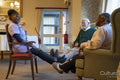 Smiling senior people exercising with nurse in nursing home