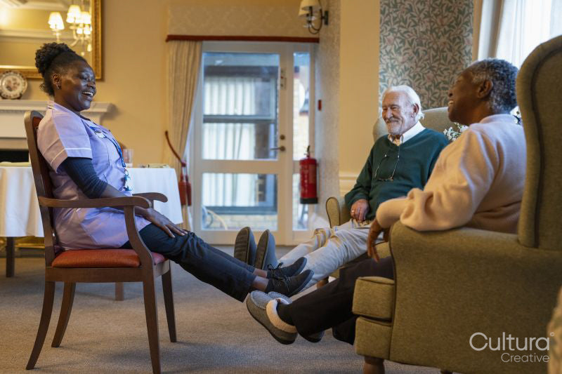Smiling senior people exercising with nurse in nursing home