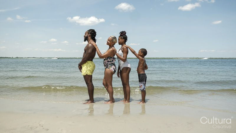 Family standing in row on beach