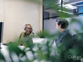 Office workers using computers in co-working office space