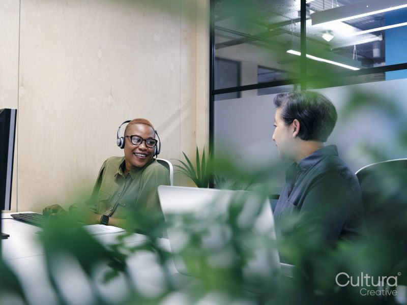 Office workers using computers in co-working office space