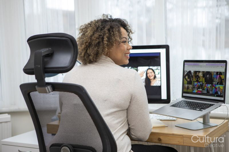 Smiling woman having video conference at home