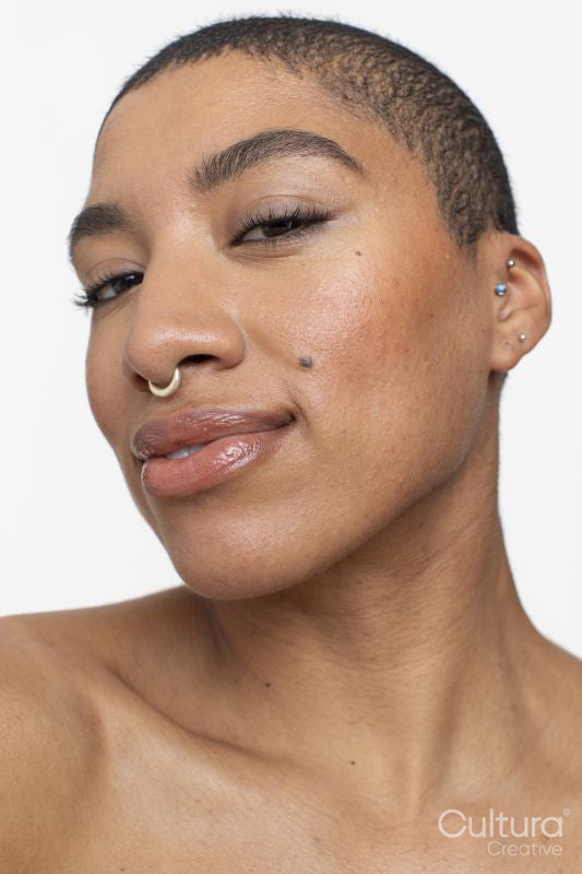 Studio portrait of woman with short hair and nose ring