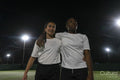 Female soccer players embracing