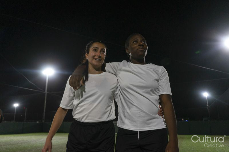 Female soccer players embracing