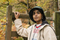 Female hiker walking through gate in forest