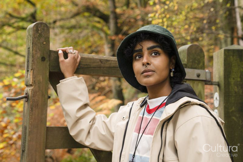 Female hiker walking through gate in forest