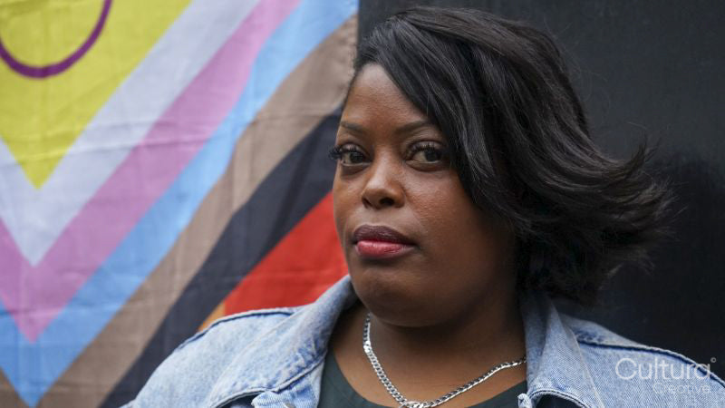 Portrait of mature woman in front of pride flag