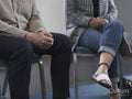 People sitting in group therapy session