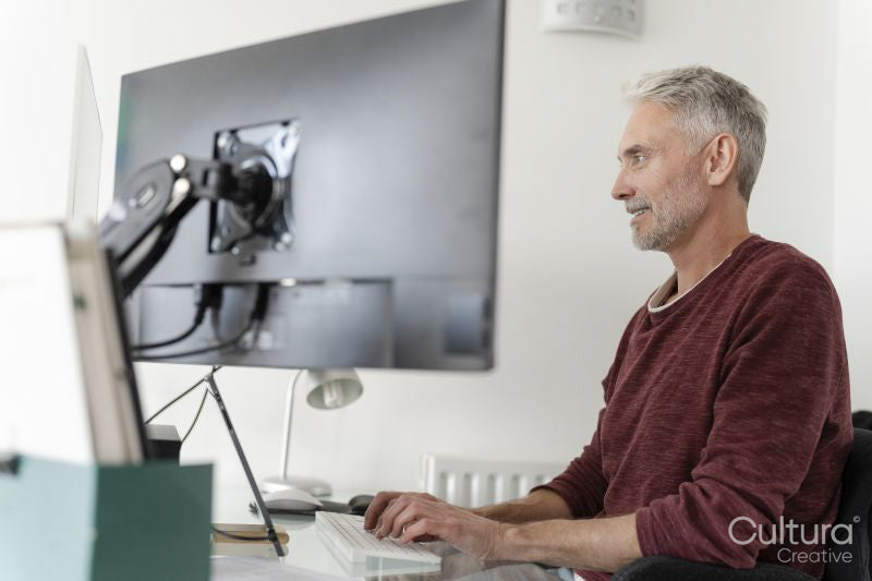Mature man working on computer at home