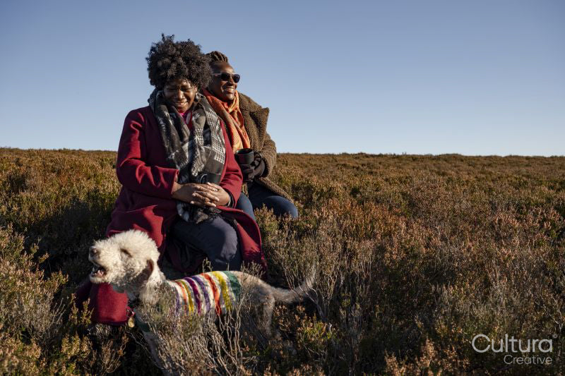 Two senior women with dog in moorland
