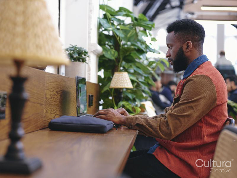 Businessman using laptop in creative studio