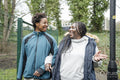 Mother and daughter talking while walking in park