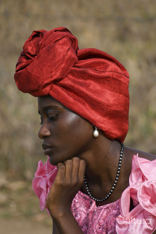 Portrait of young woman wearing red headscarf