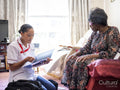 Elderly woman talking with nurse
