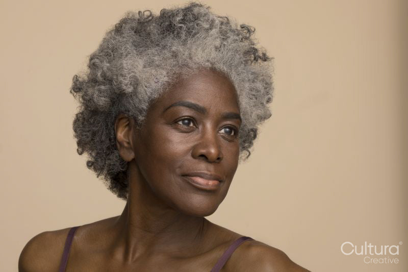 Studio portrait of smiling mature woman