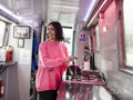 Smiling young woman in kitchen on boat