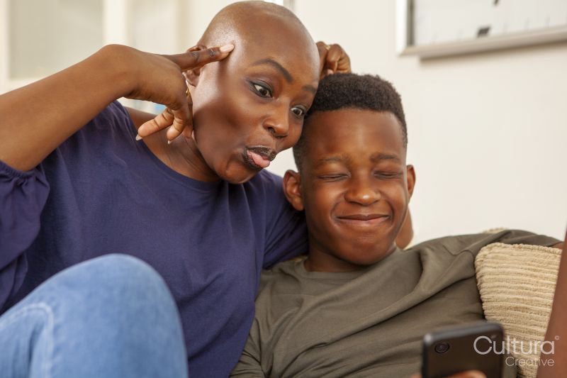 Mother and son taking selfie and making faces