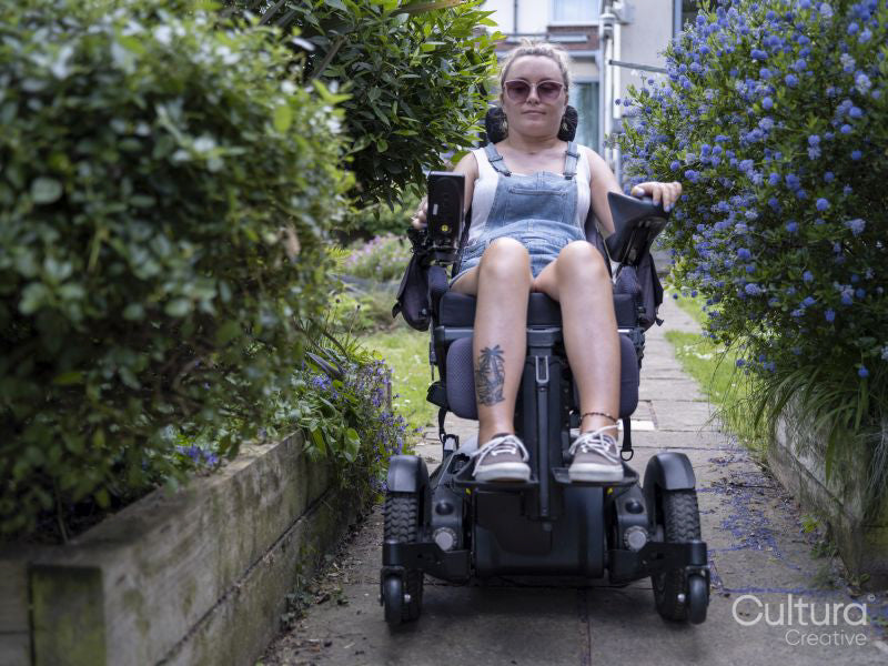 Woman in electric wheelchair outdoors