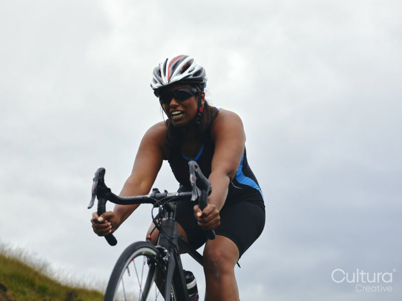 Female cyclist in cycling helmet and sunglasses