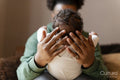 Father holding baby daughter at home