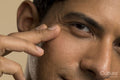 Close-up of man touching face