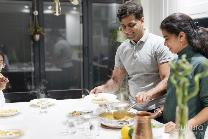 Husband and wife putting food on plates