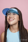 Studio portrait of smiling girl wearing sun visor