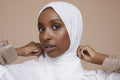 Studio portrait of young woman wearing white hijab