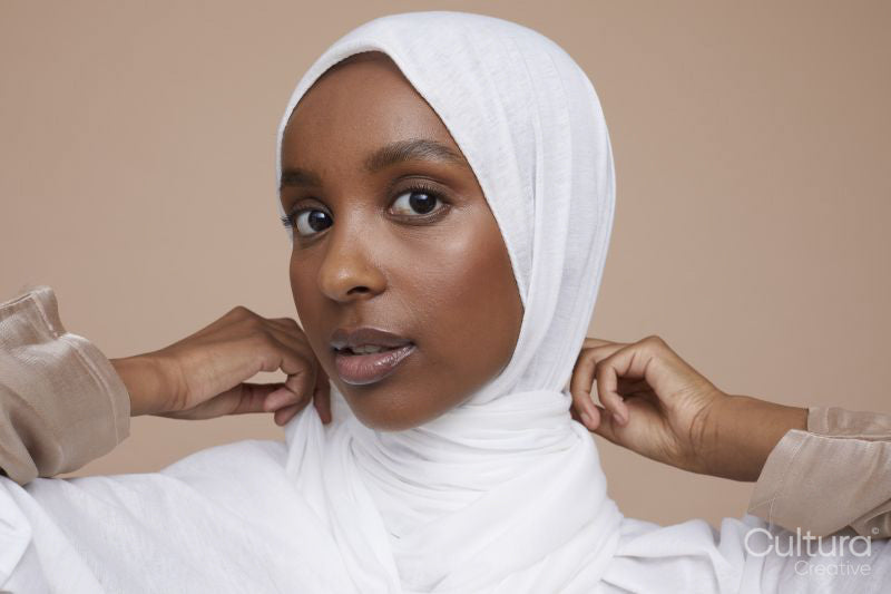 Studio portrait of young woman wearing white hijab