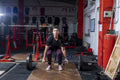 Woman lifting weights at cross training gym
