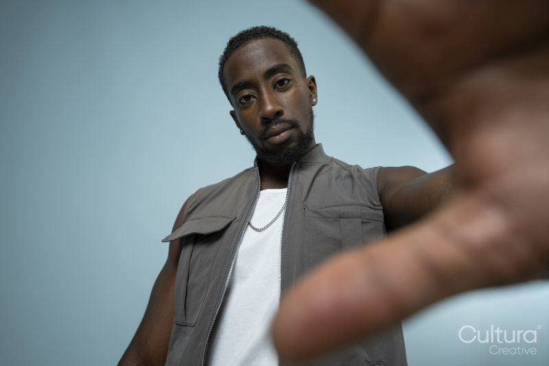 Man looking at camera, reaching with hand