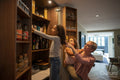 Mother and daughters removing products from pantry