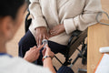 Close-up of female doctor using oximeter to measure senior patients blood saturation
