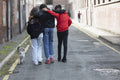 Friends with dog walking on street
