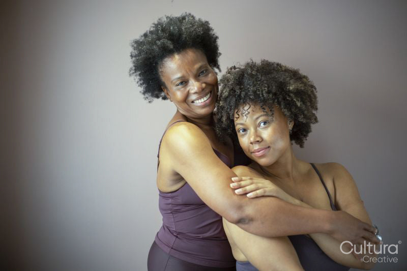 Studio portrait of smiling mother and daughter wearing lingerie
